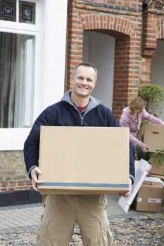 Commercial moving professionals handling office equipment