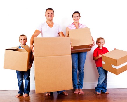 Professional movers packing boxes